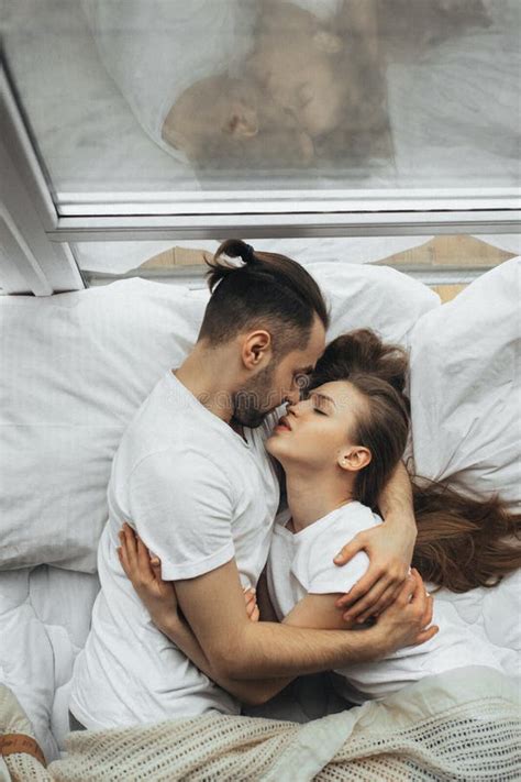 Young Couple Hugging and Caressing in Bed